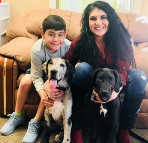 Picture of Ashley Romero, with her son and dogs.