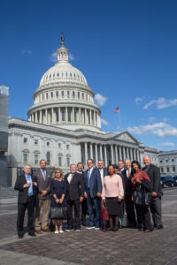 PSM's briefing speakers and family members of victims gather in front of the U.S. Capitol