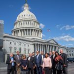 PSM's briefing speakers and family members of victims gather in front of the U.S. Capitol