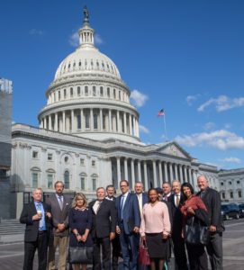 PSM's briefing speakers and family members of victims gather in front of the U.S. Capitol