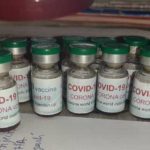 glass vials labeled COVID-19 vaccine