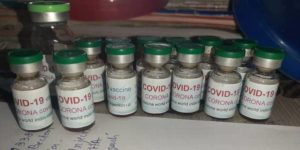 glass vials labeled COVID-19 vaccine
