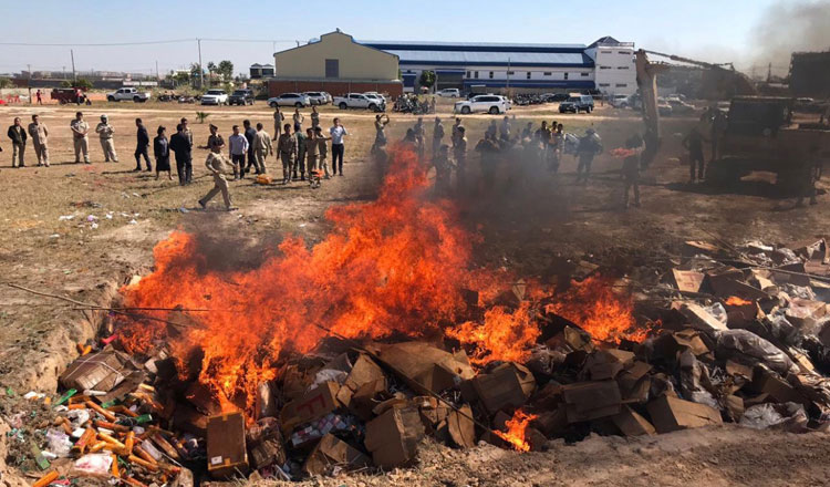 Fire destroying counterfeit goods in an open area