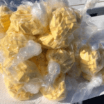yellow pills in a clear plastic bag