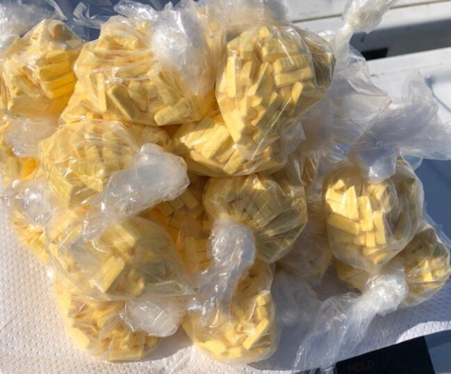 yellow pills in a clear plastic bag