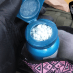 Pills in a blue bottle