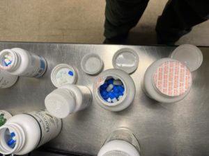 vitamin bottles with illicit pills in them