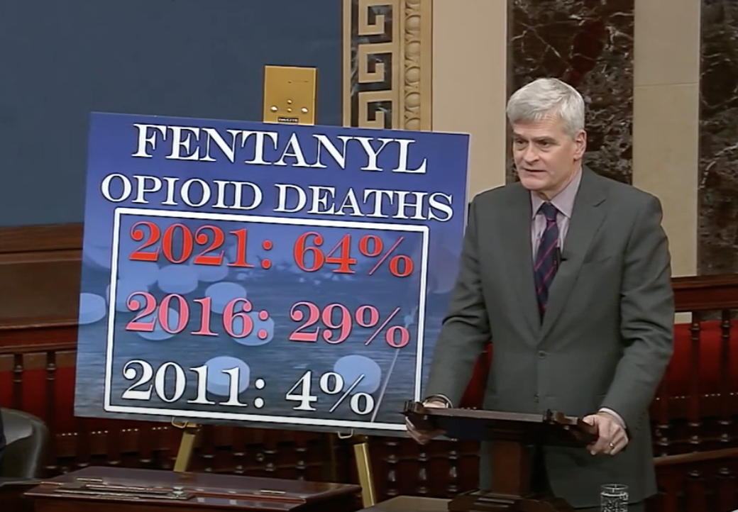 Senator Cassidy on the U.S. Senate floor with sign about fentanyl deaths