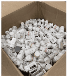 jumbled box of bottles of medicine