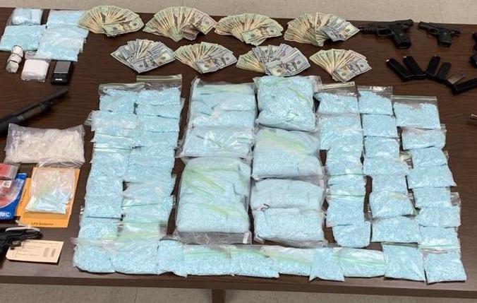 Police crystal methamphetamine, 185,000 blue counterfeit M/30 pills and more than $12,000 in cash. (Longview Police Department)