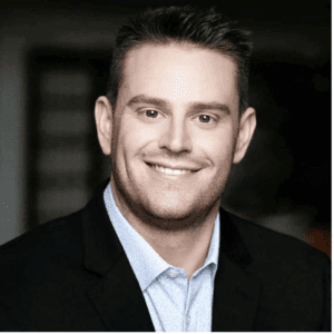 business head shot of smiling white man with dark hair