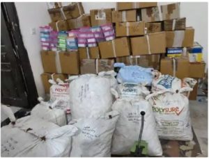 white bags and cardboard boxes piled haphazardly in a storage room