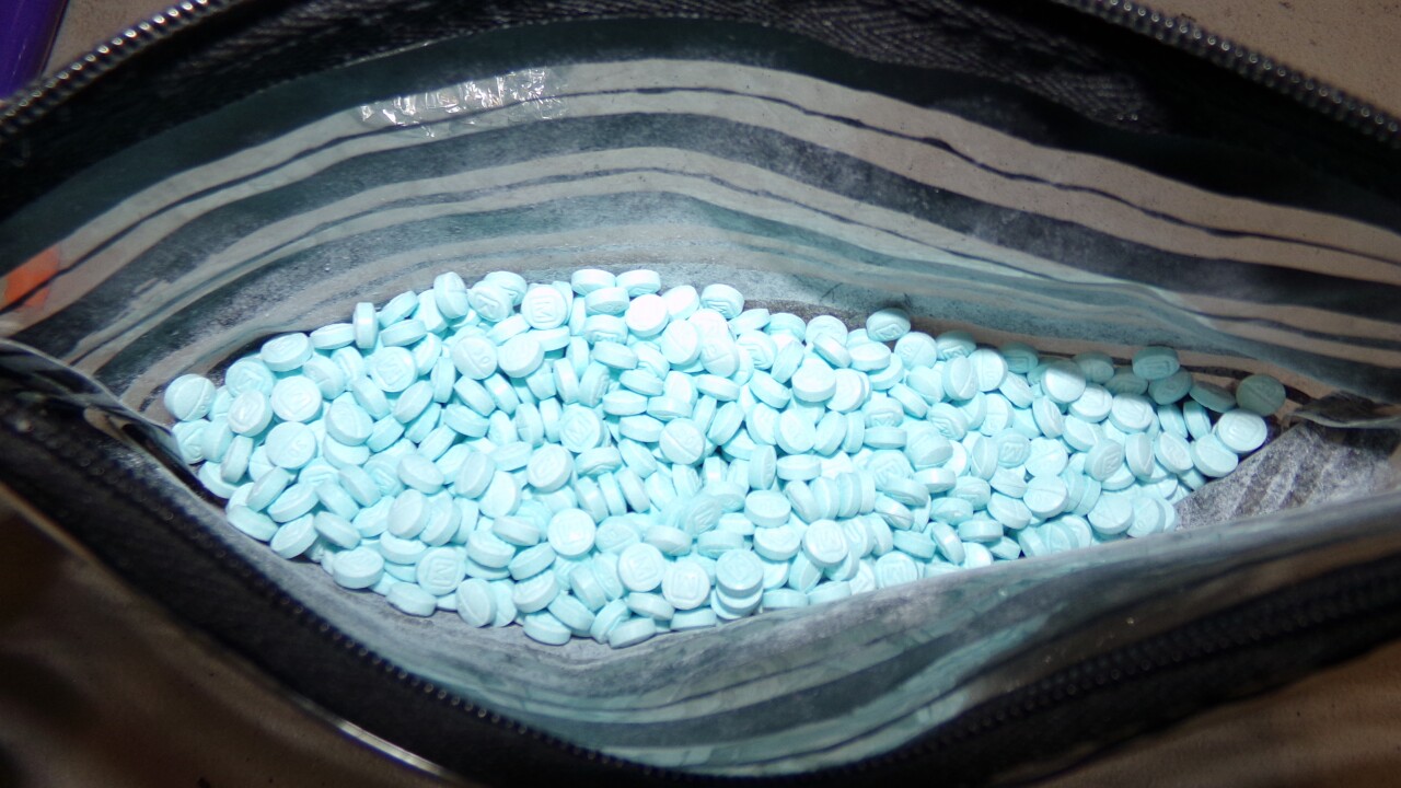 Top view into an open zippered bag of fentanyl pills