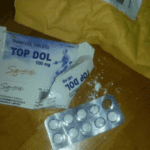 A smashed box of pills with a blister pack. it's labeled Top Dol,” an Indian formulation of the Schedule IV opioid, tramadol.