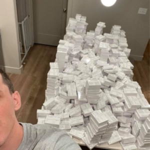 stack of a huge number of white cards viewed over a person's shoulder