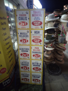 red and blue ads for commonly prescription drugs displayed at a Mexican pharmacy