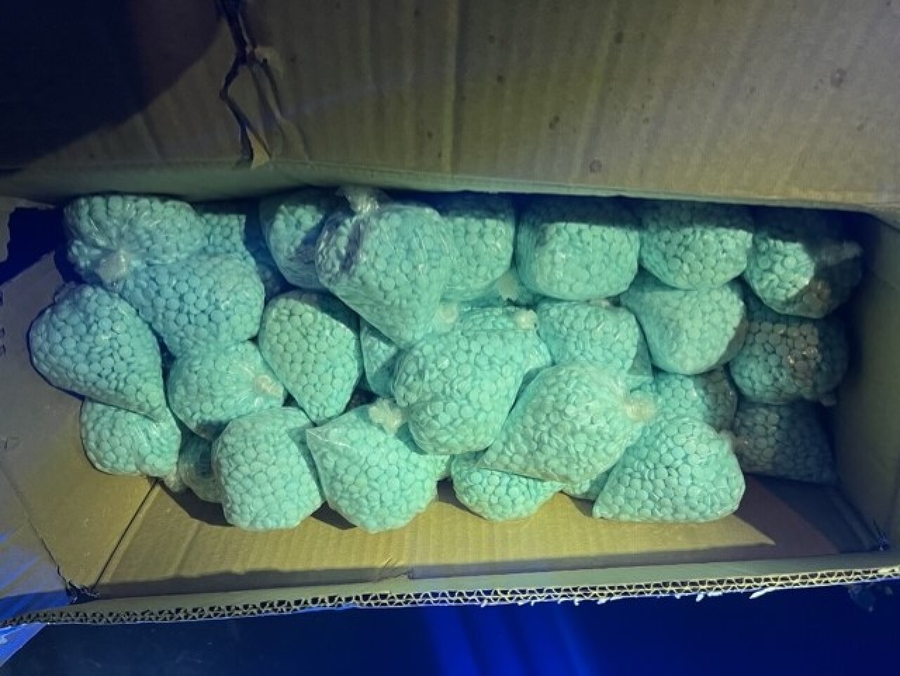 clear plastic bags of turquoise pills