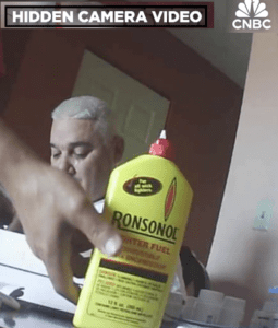 closeup of a hand holding lighter fluid