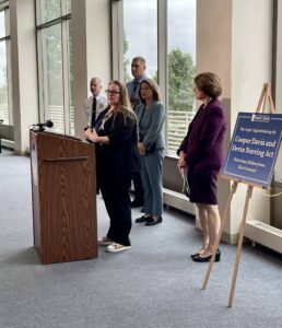 Image of people gathered around a podium.