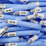 A pile of unbranded, blue injection pens.